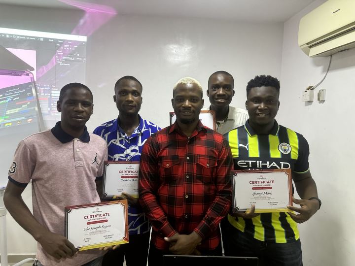 Graduates holding their certificates with Nas
